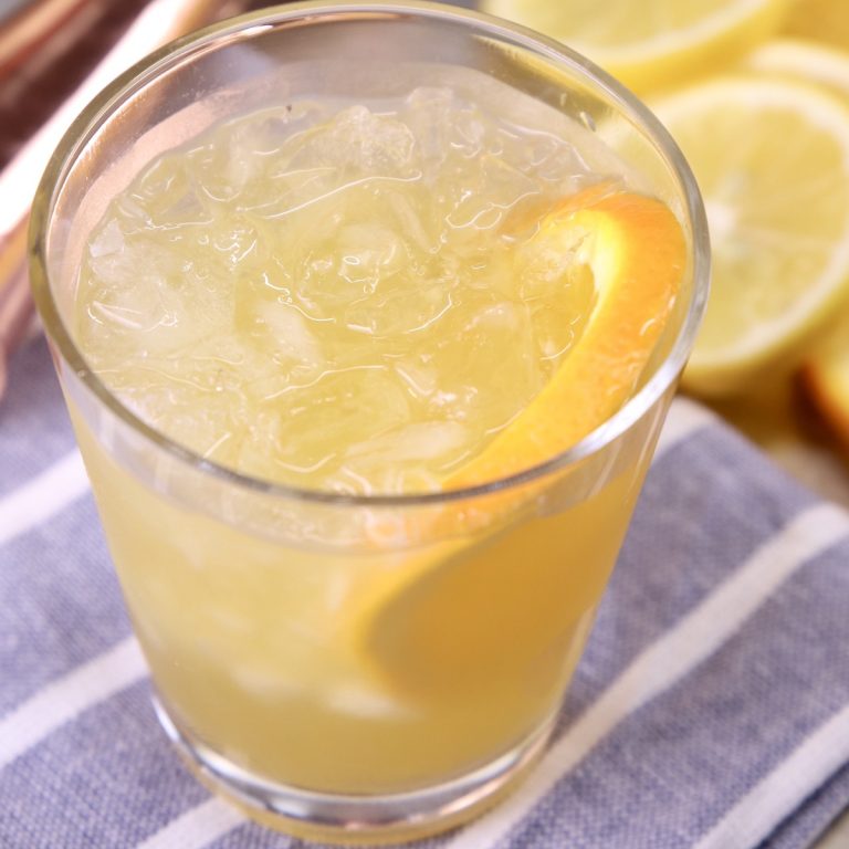 Amaretto and Irish Whiskey cocktail with orange slice in glass with crushed ice