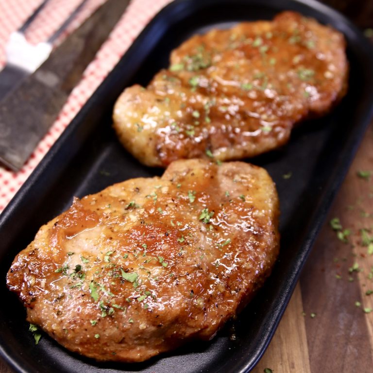 Apricot Pork Chops on a black platter