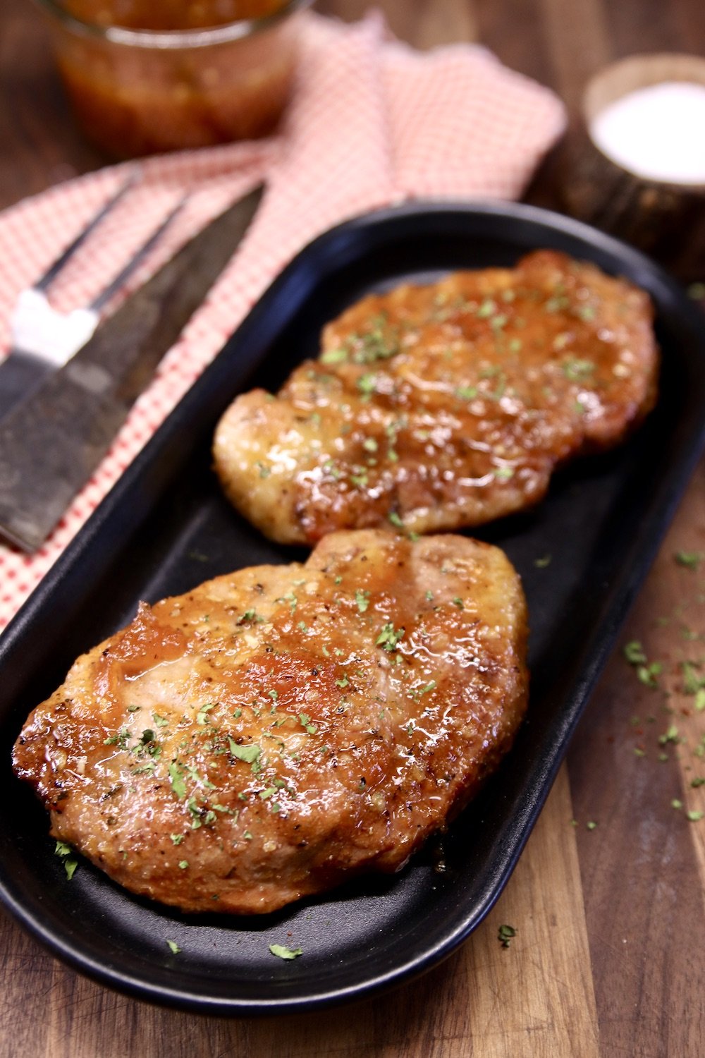 2 Apricot Pork Chops on a black platter