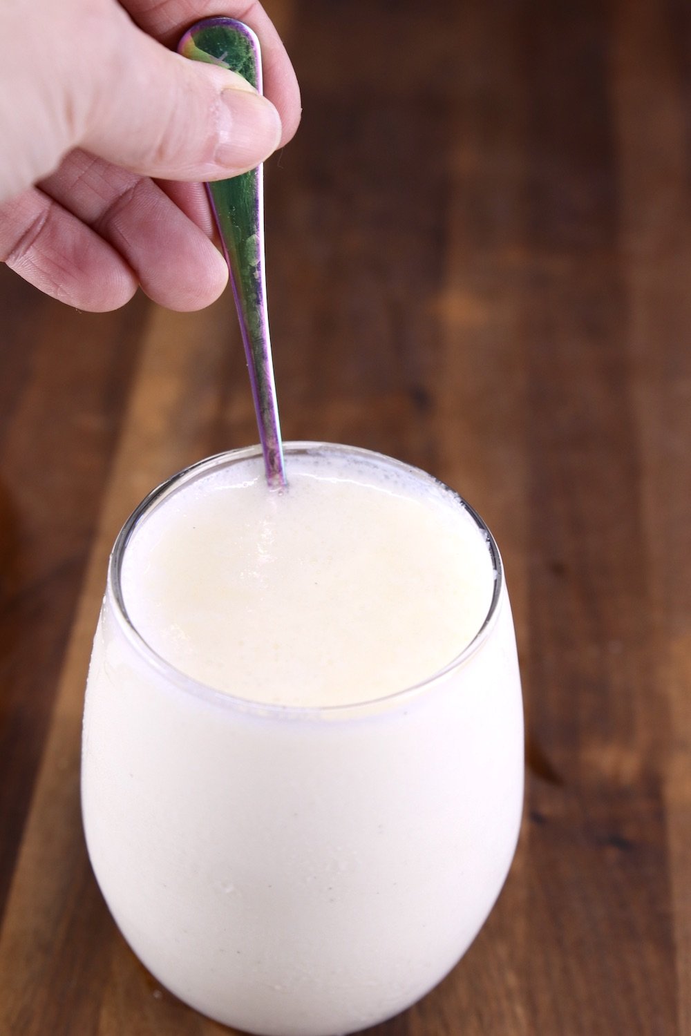 Stirring frozen lemonade with a cocktail spoon