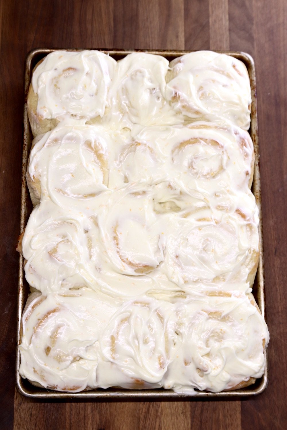 pan of cream cheese iced sweet rolls