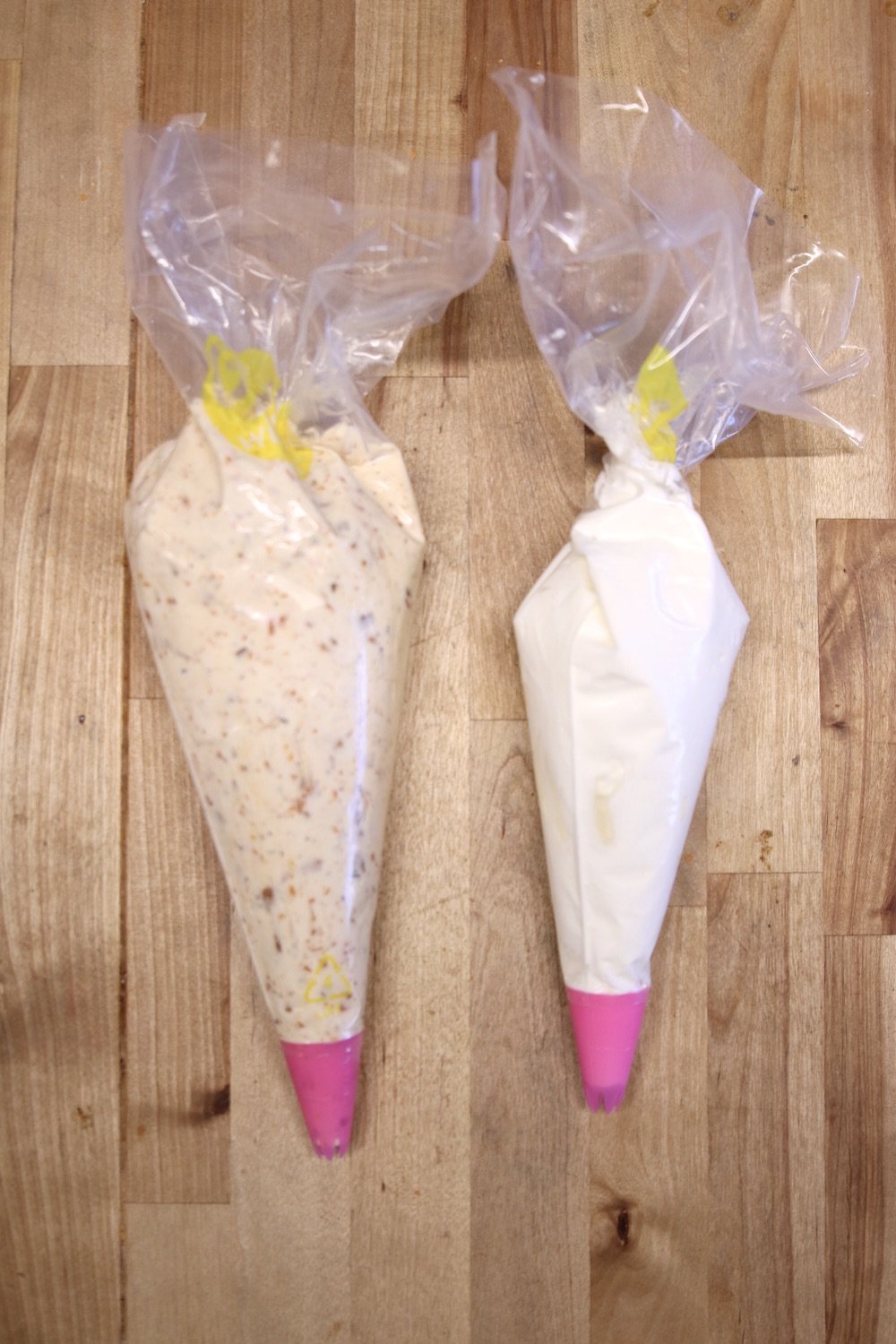piping bags with cheesecake filling and whipped cream
