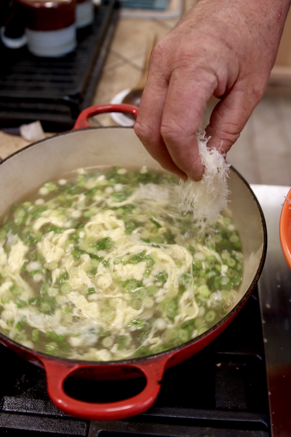 Adding parmesan cheese to Italian Egg Drop Soup