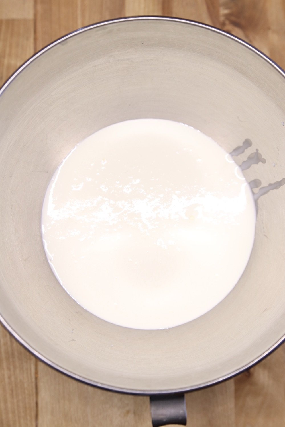 Whipping cream in a mixer bowl