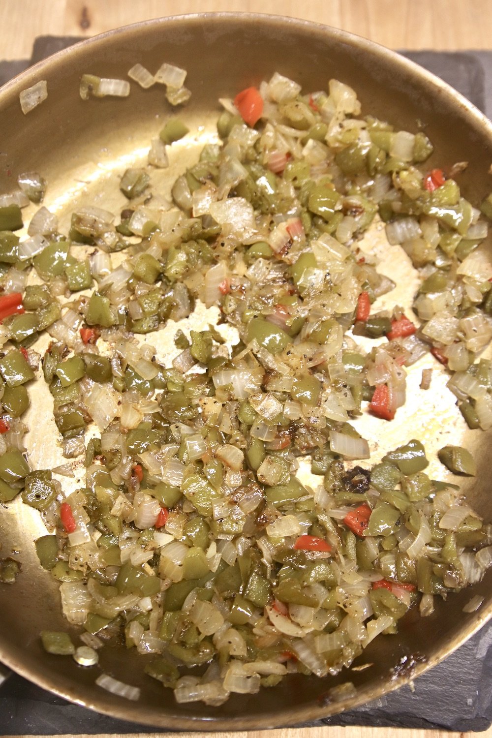 skillet with cooked peppers and onions