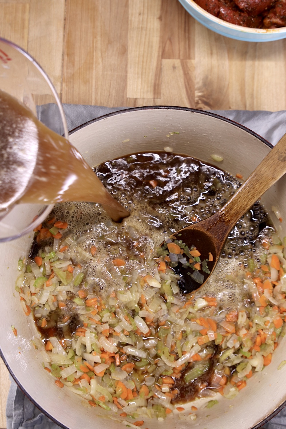 Beef broth added to vegetables for stew
