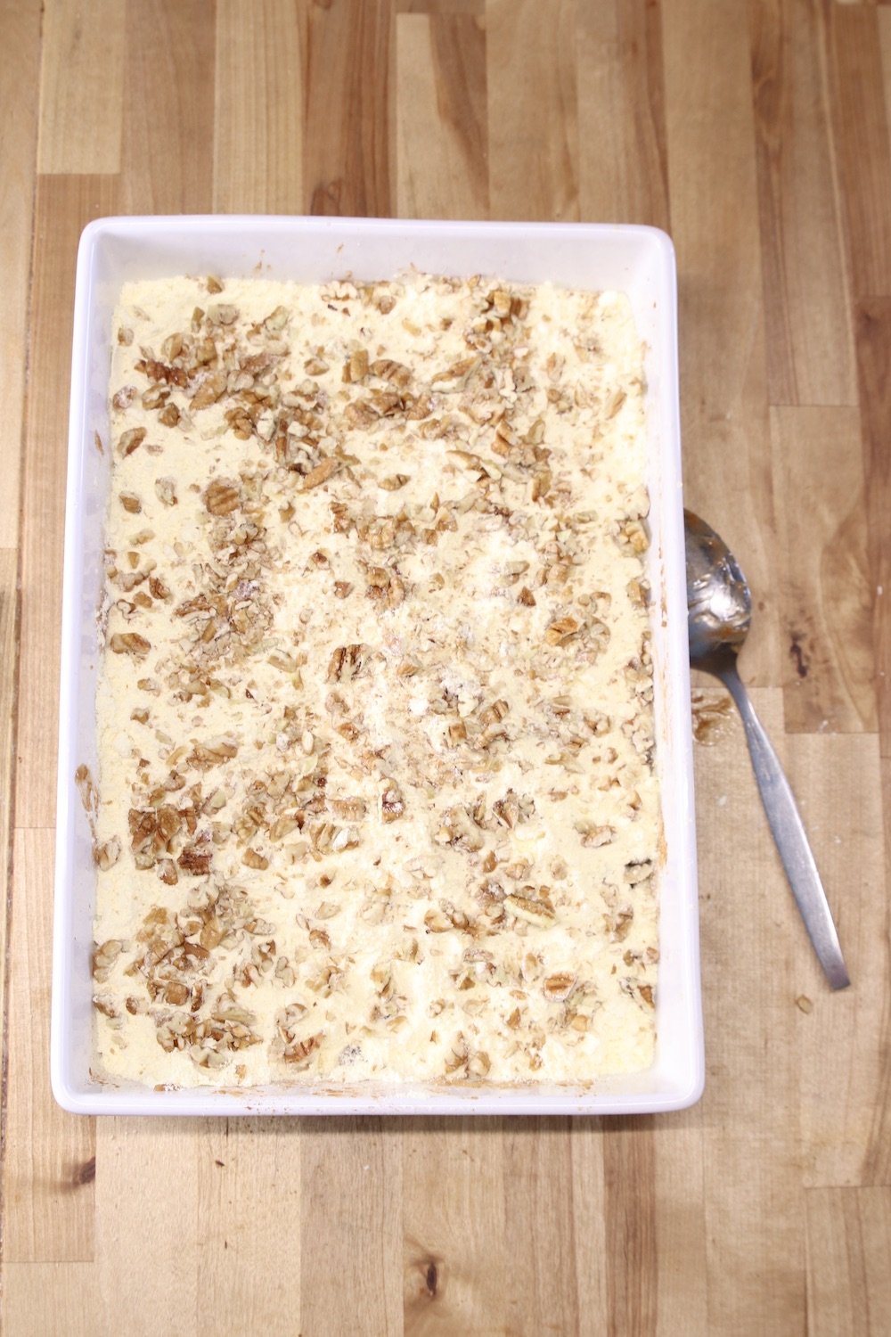 cake mix and pecans sprinkled in cake pan