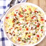 bowl of pasta salad with bacon, tomatoes and green onions