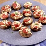 bruschetta topped potatoes on a platter