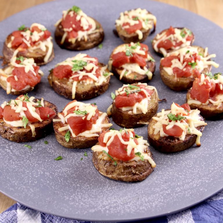 bruschetta topped potatoes on a platter