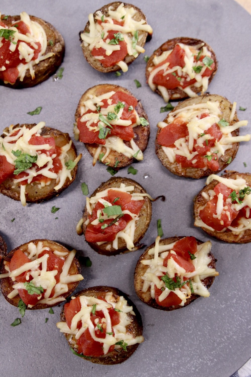 Bruschetta Butter Potatoes on a gray tray