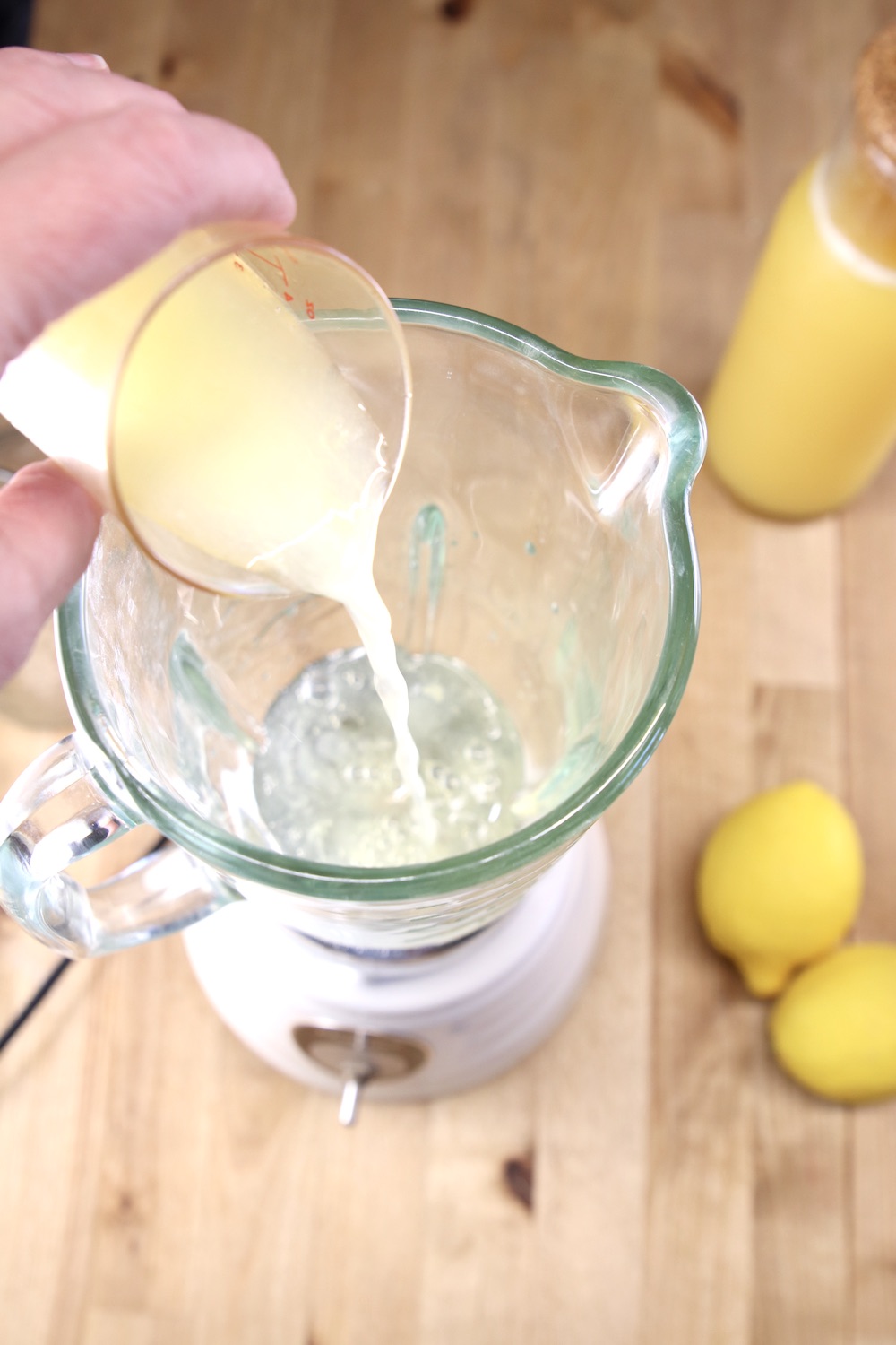 pouring lemon juice into blender