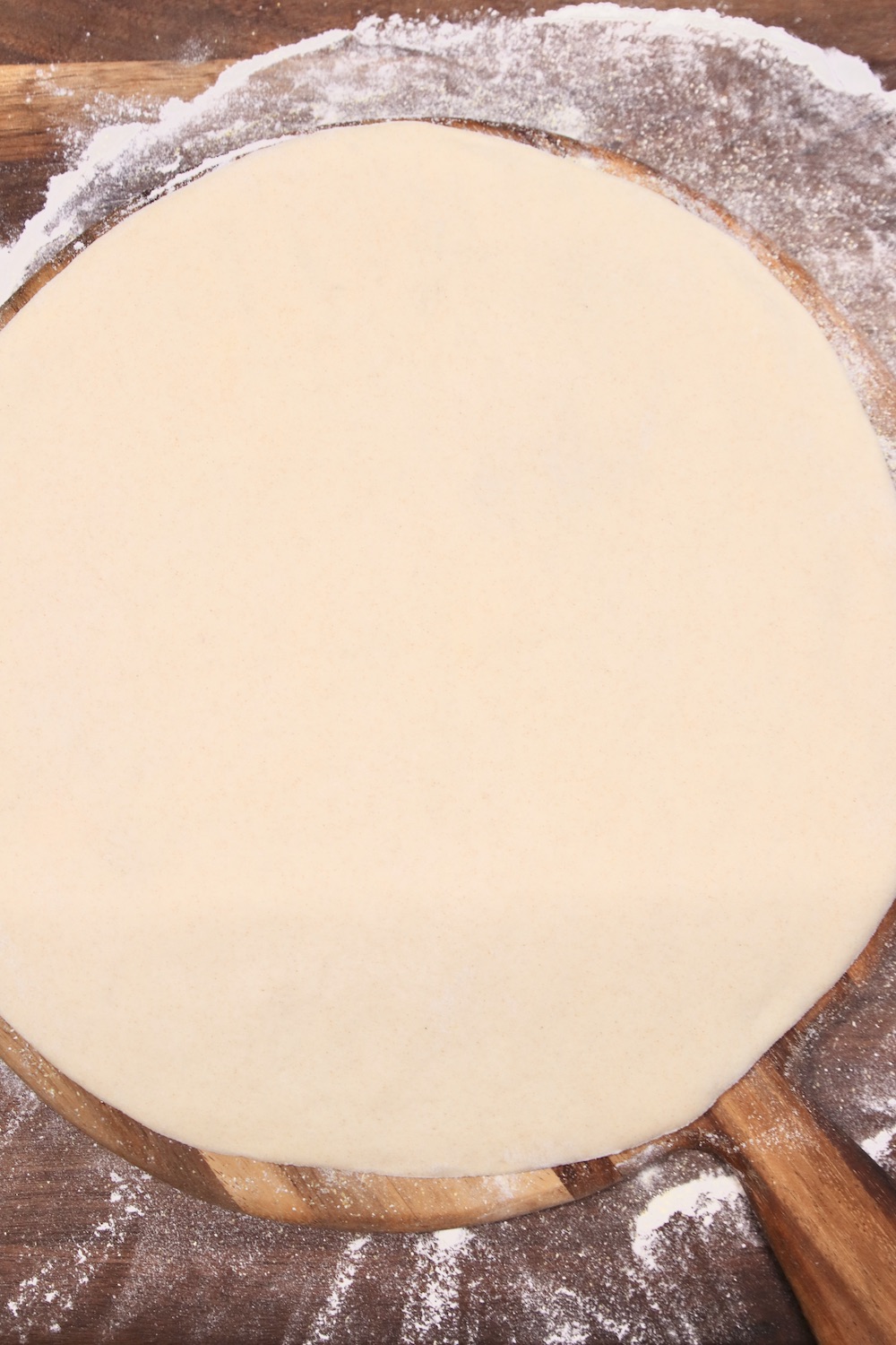 pizza dough circle on a pizza peel