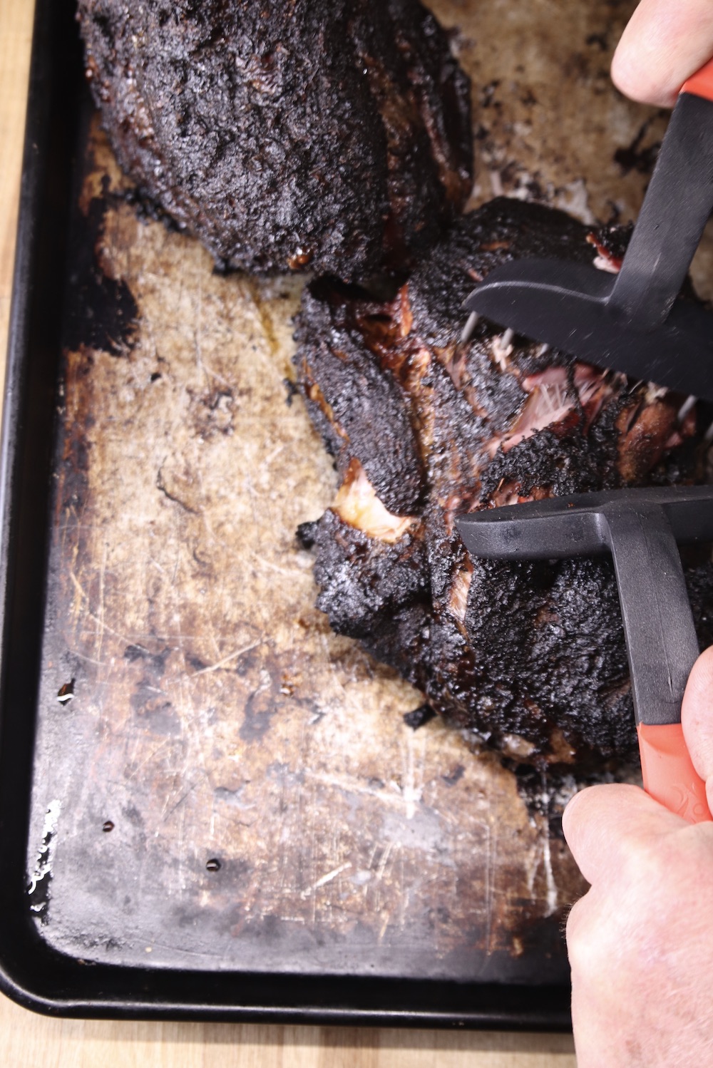 shredding smoked pork shoulder with meat claws