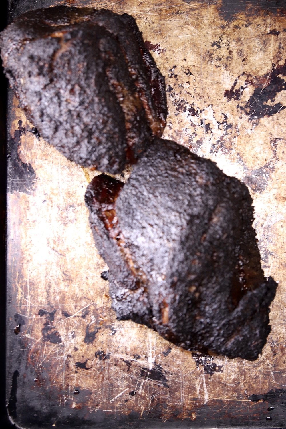 2 smoked pork shoulders on a sheet pan