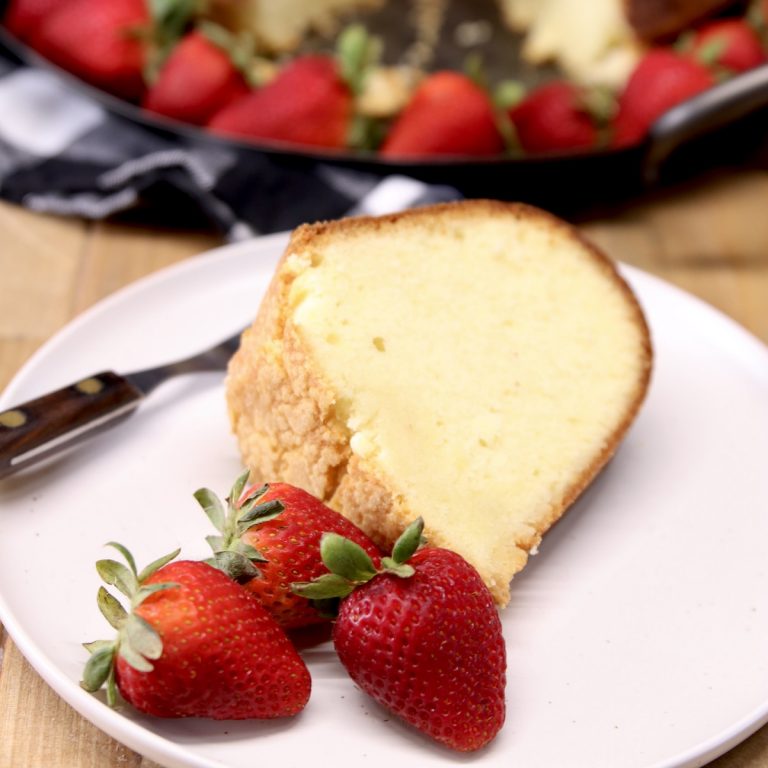 slice of Amaretto pound cake with strawberries on a plate
