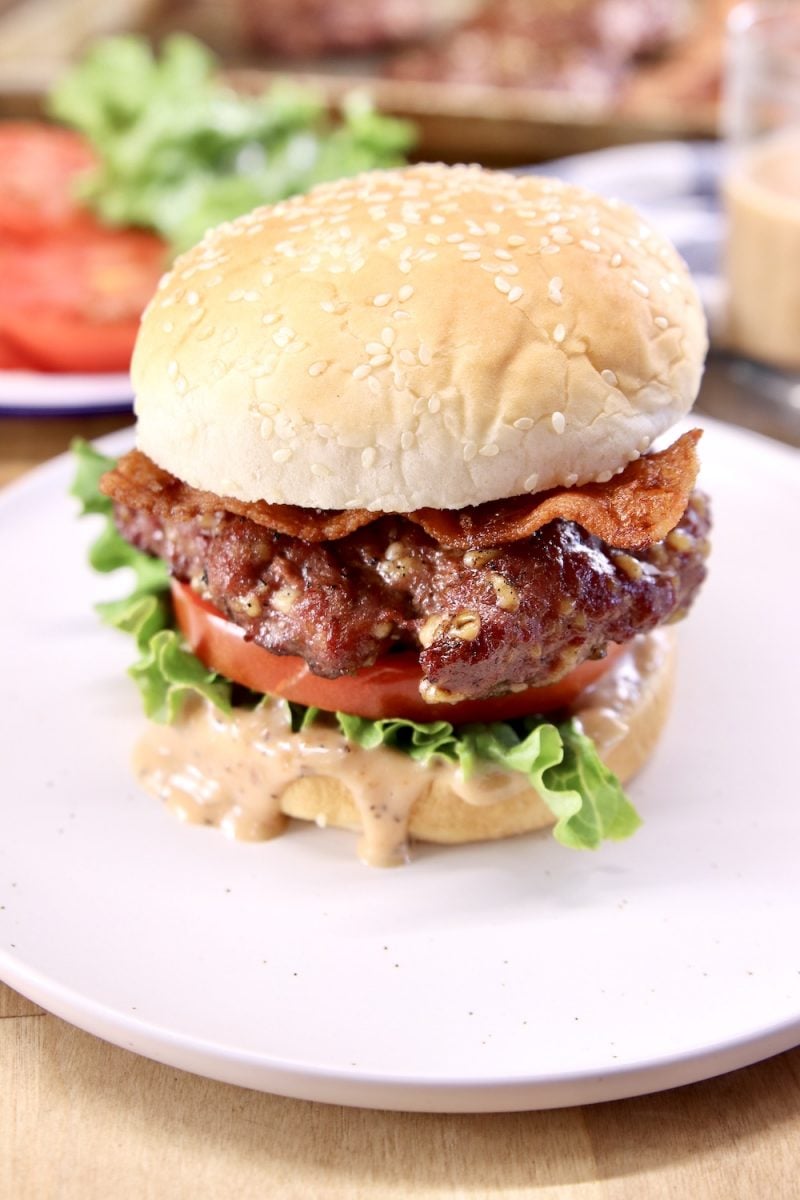 Grilled burger with lettuce, tomato, bacon