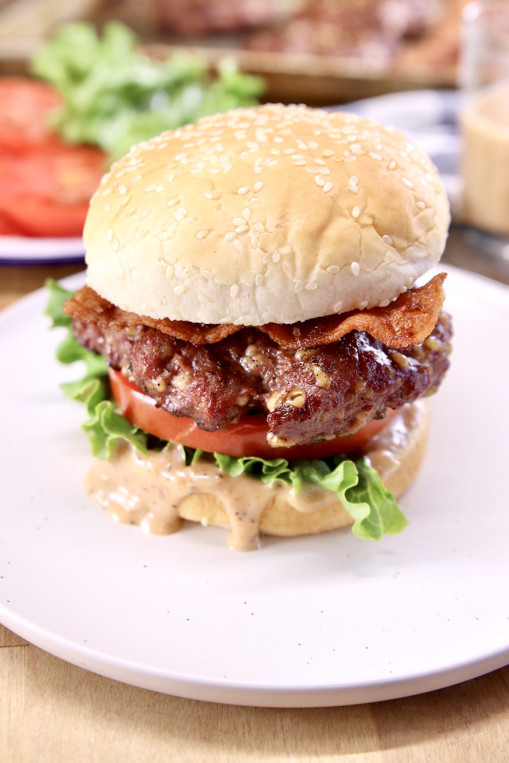 Grilled burger with lettuce, tomato, bacon