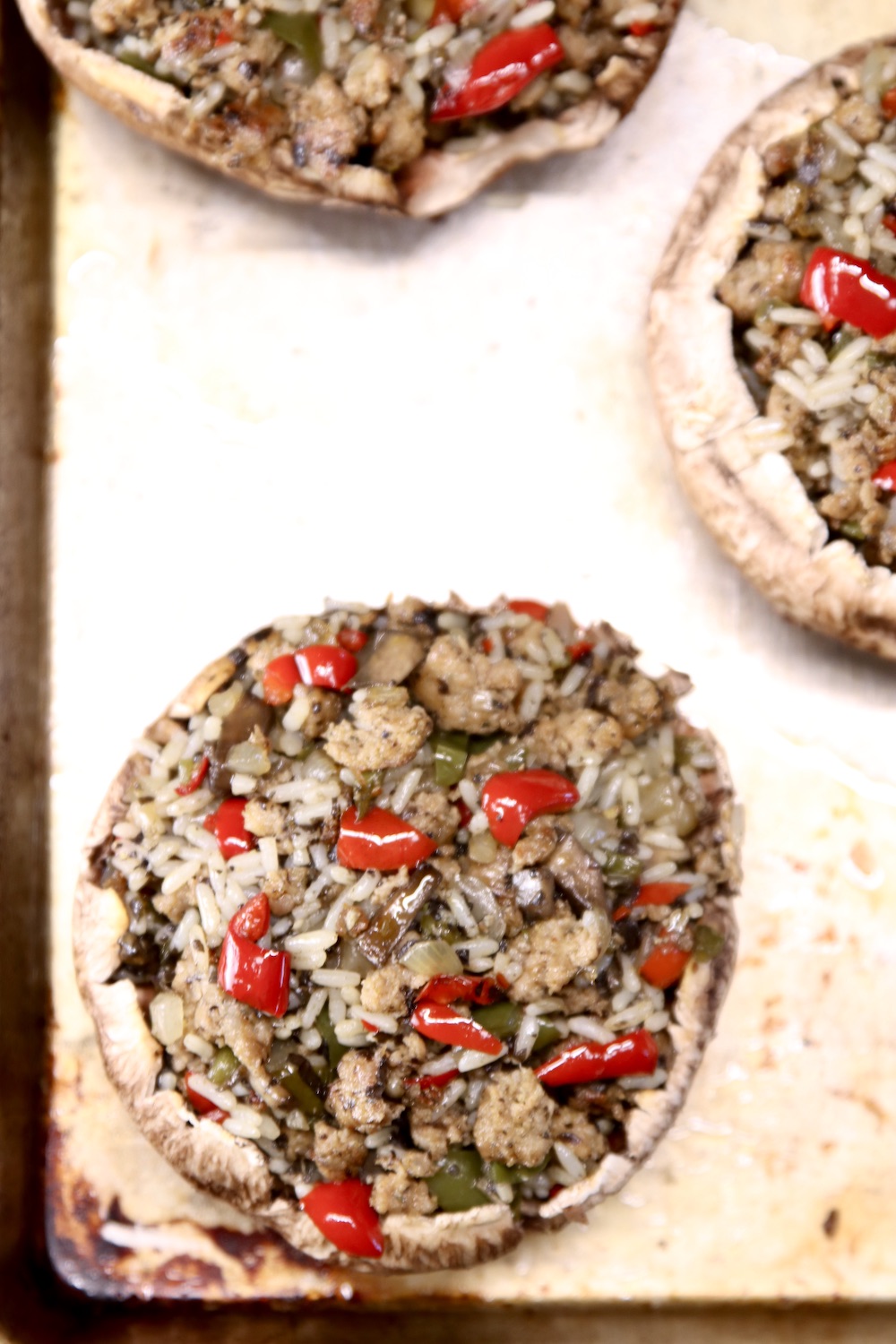stuffed portobello mushrooms on a sheet pan before grilling