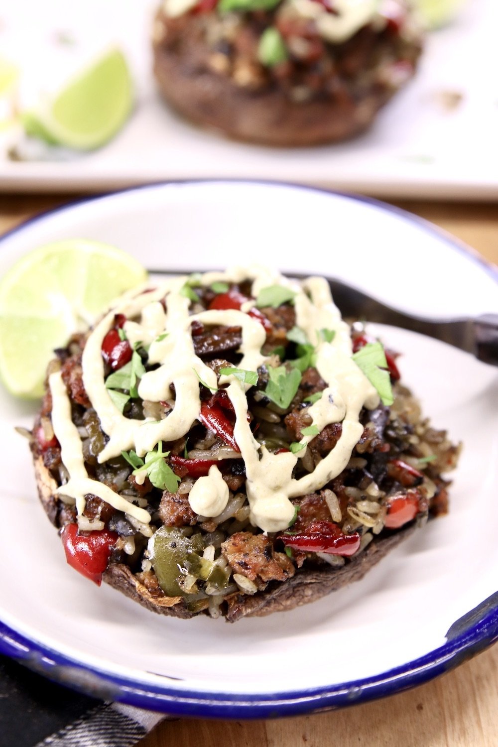 Stuffed Portobello Mushroom with cream sauce drizzle on a plate