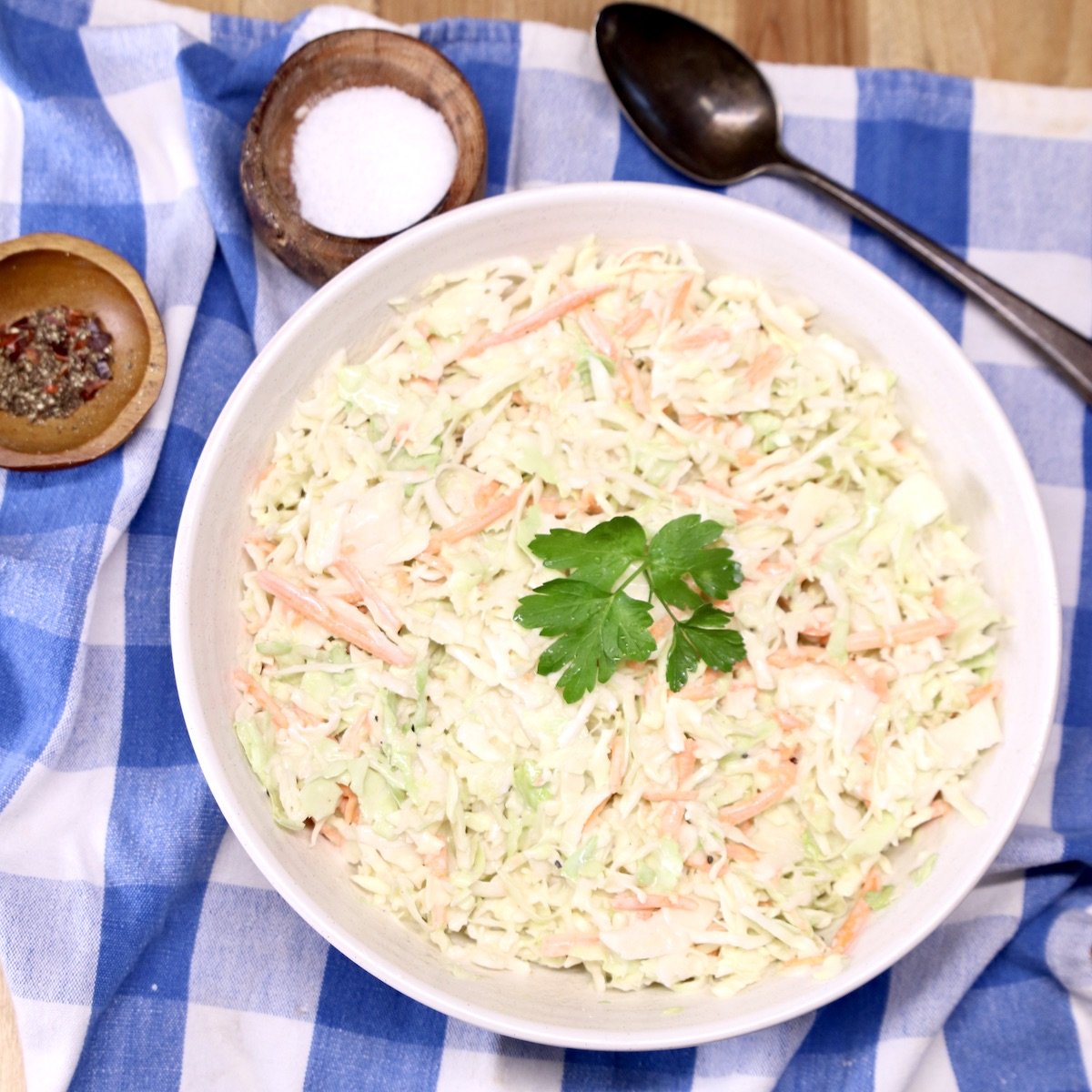 bowl of coleslaw on a blue check napkin