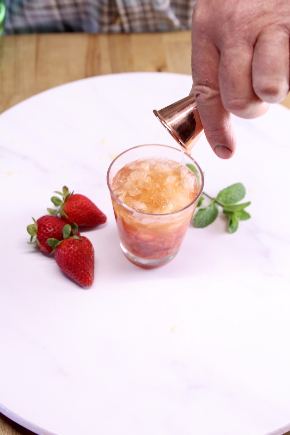 pouring sprite into cocktail glass