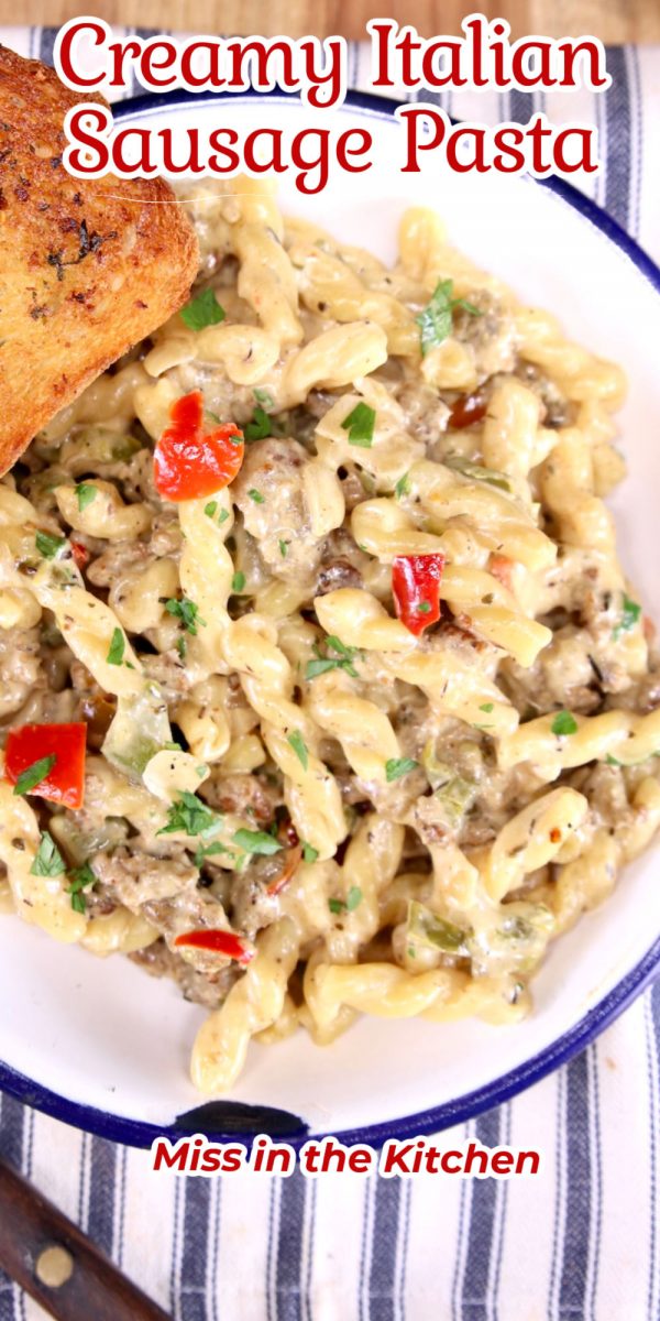 Creamy Italian Sausage Pasta in a bowl - text overlay