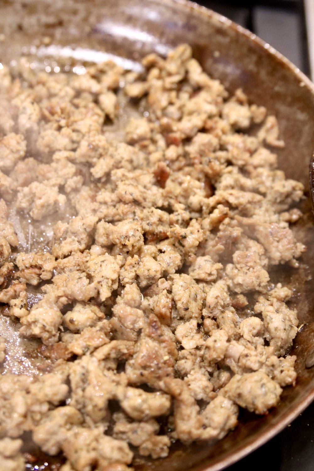 browned Italian sausage in a skillet