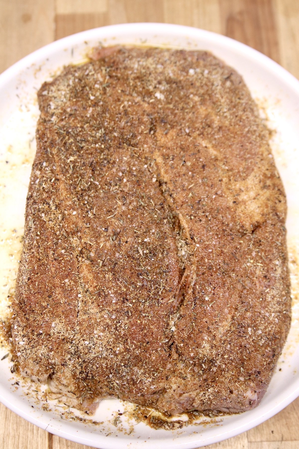 chuck roast coated with dry rub ready to grill