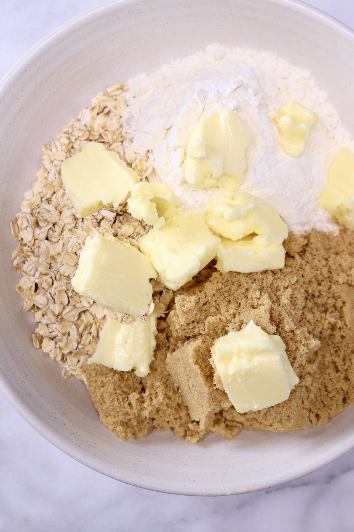 bowl with brown sugar, flour, oats, butter cut up 