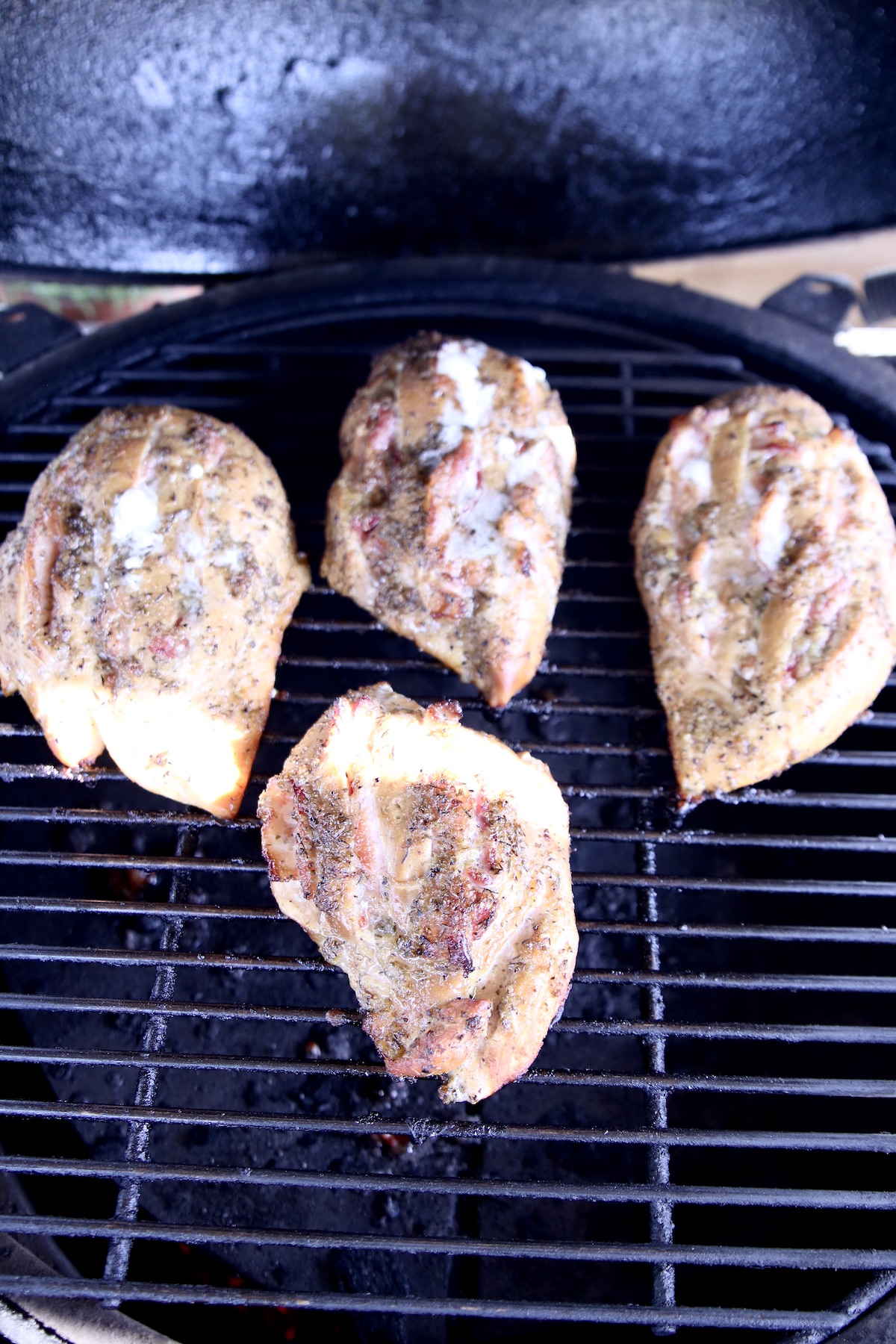 Grilled chicken breasts stuffed with bacon on grill