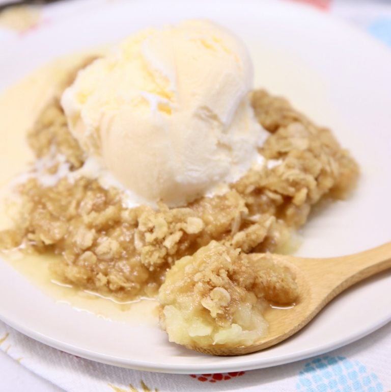 Pineapple Crisp on a plate topped with vanilla ice cream