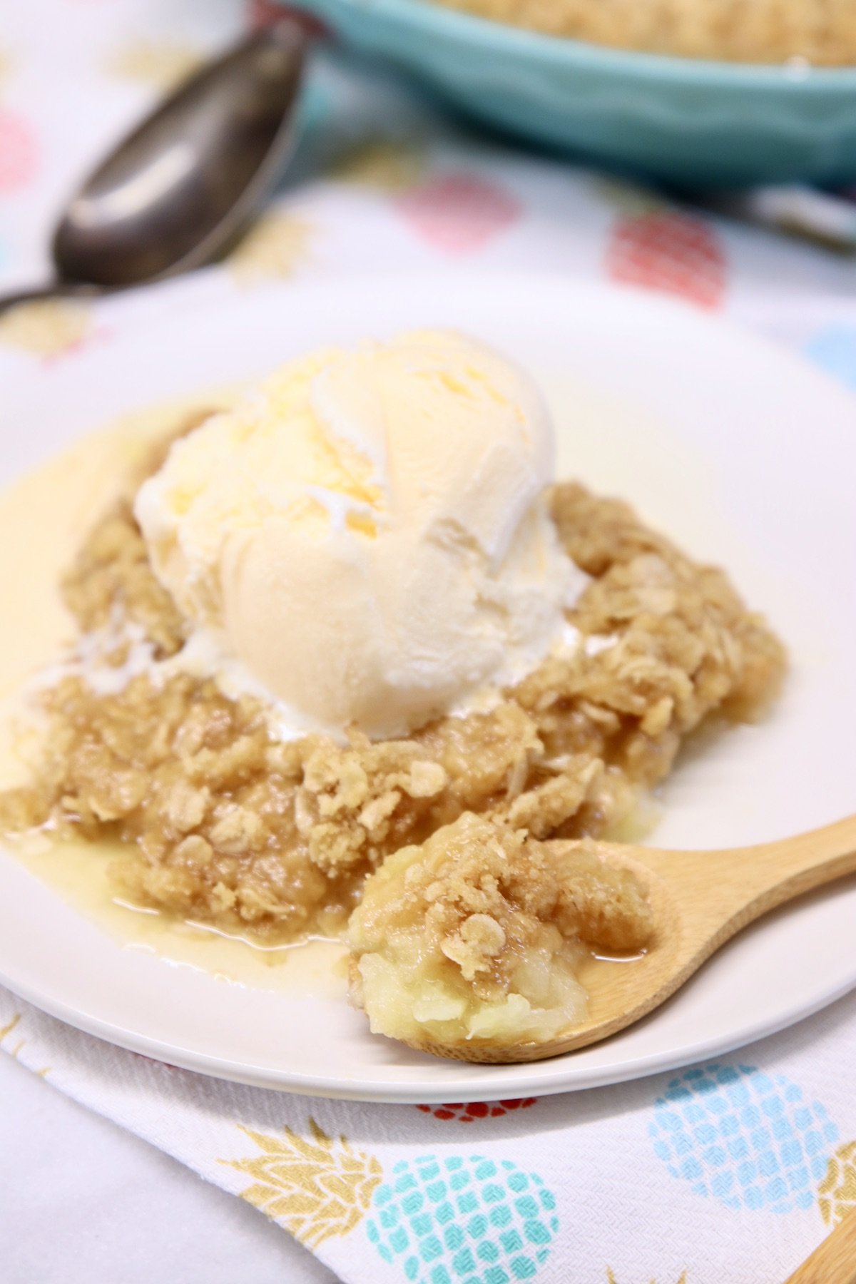 Pineapple Crisp on a plate with vanilla ice cream