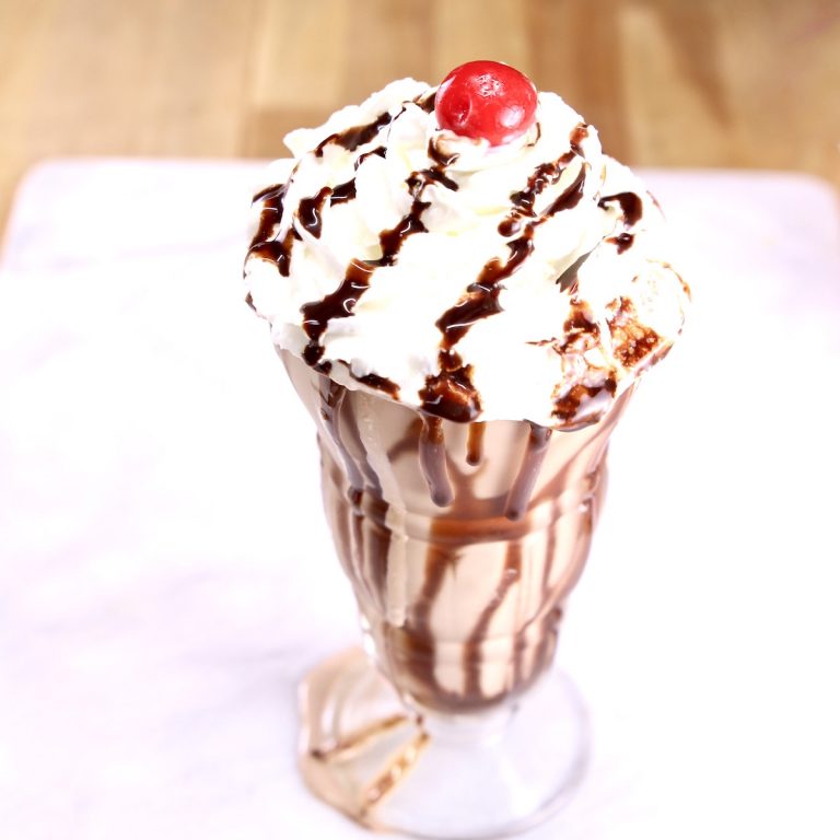 Baileys chocolate shake with whipped cream, chocolate sauce and a cherry on top