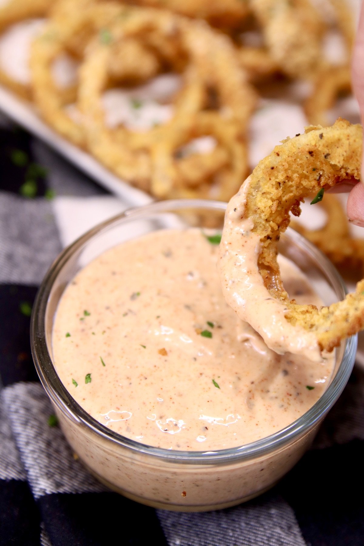 Blooming Onion Sauce is a copycat version of the Outback Steakhouse dipping sauce perfect for their famous bloomin onion. A flavorful sauce that is simple to make with pantry ingredients. Blooming Onion Sauce with onion ring dipping