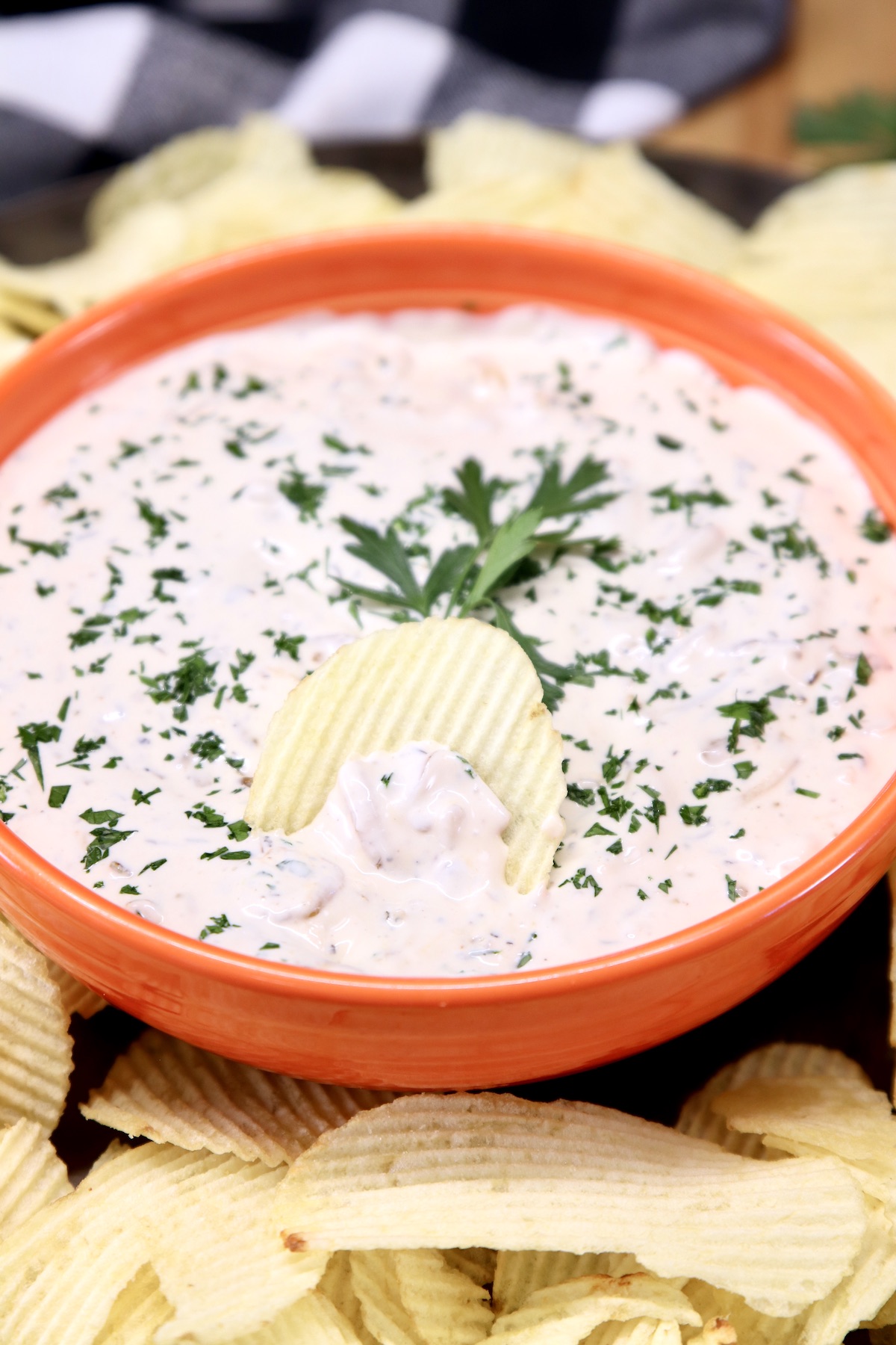 orange bowl of onion dip with Ruffles potato chips