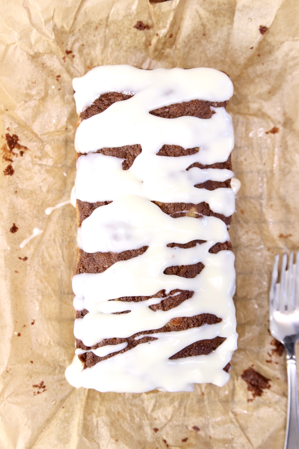cream cheese glazed apple bread on parchment paper