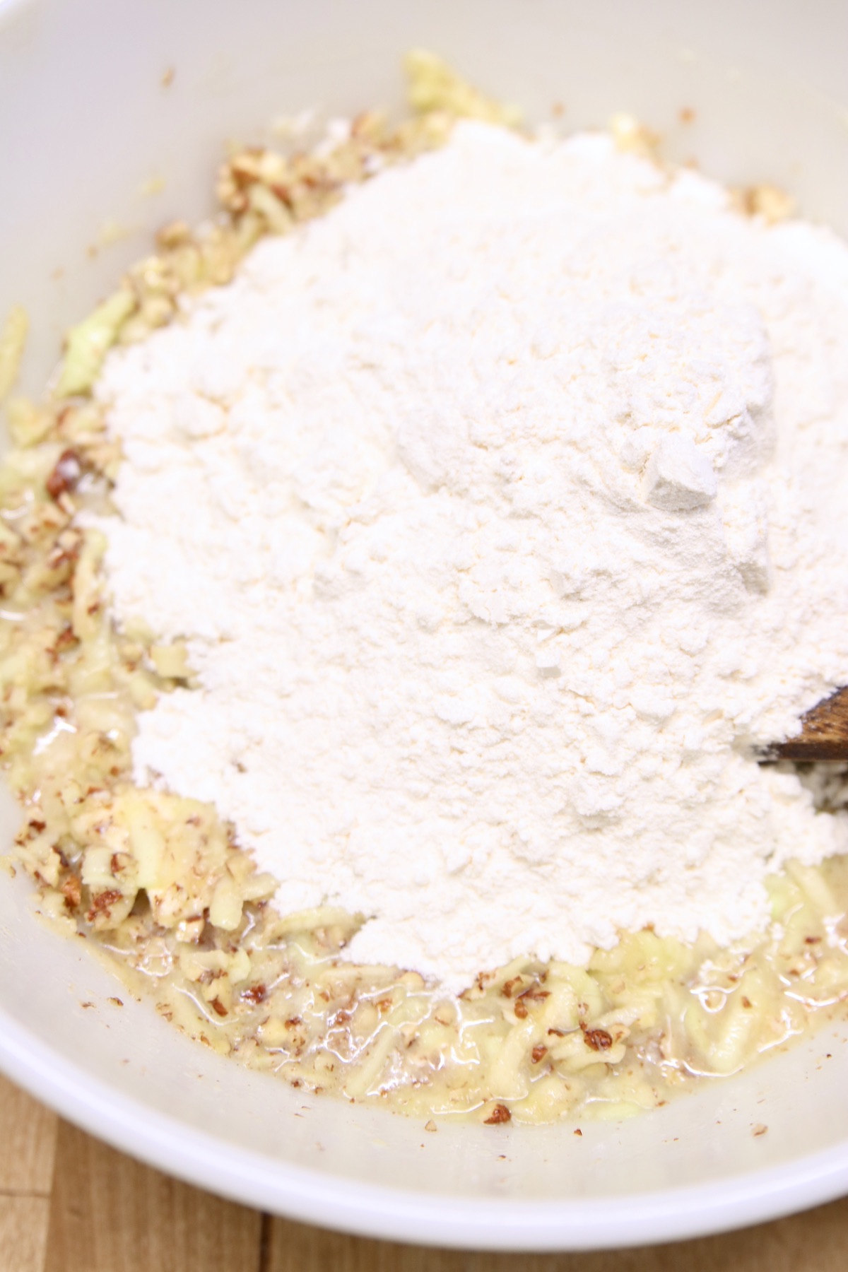 adding flour to apple bread batter