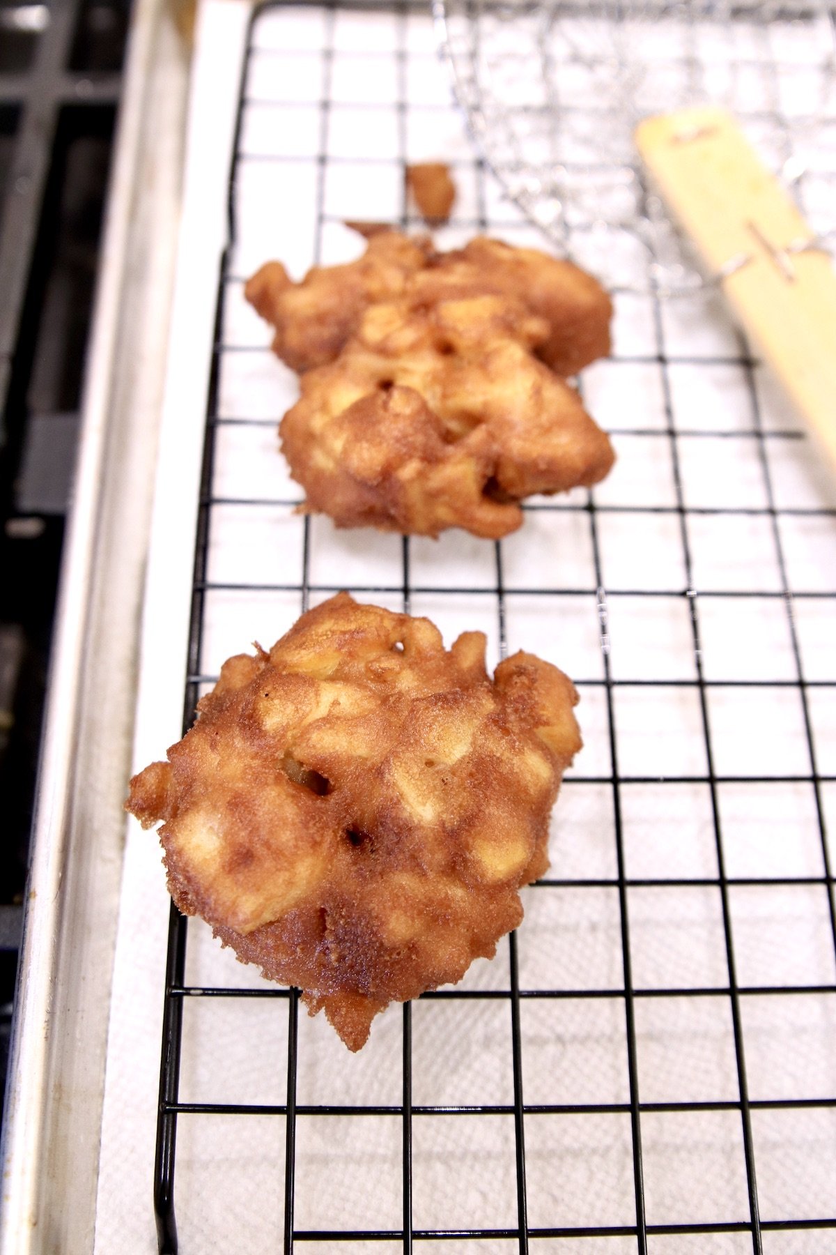apple fritters on a wire rack