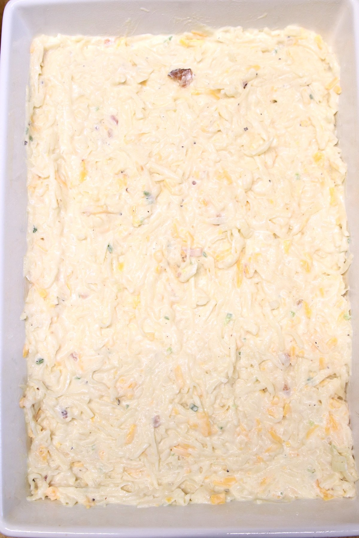 hashbrown casserole mixture in a 9 x 13 baking dish