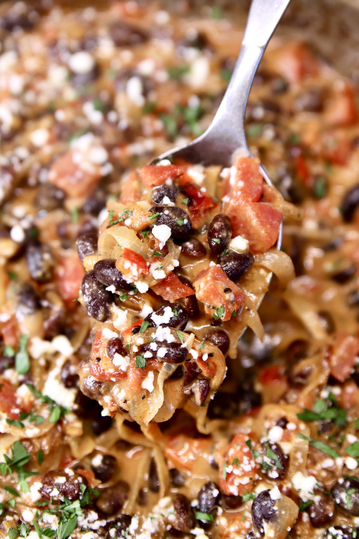 spoonful of black beans with tomatoes