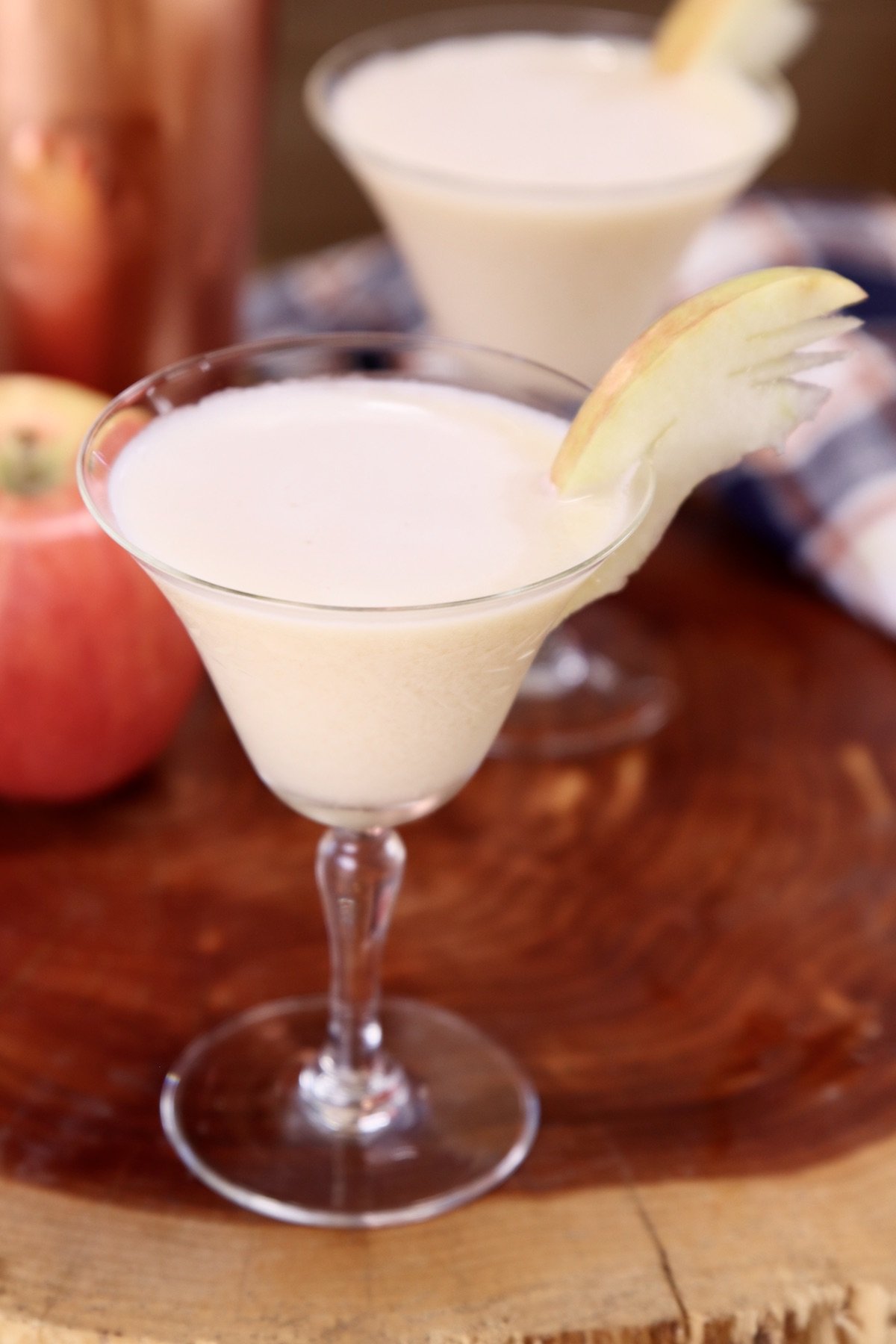 caramel apple martini in a coupe glass with apple fan garnish