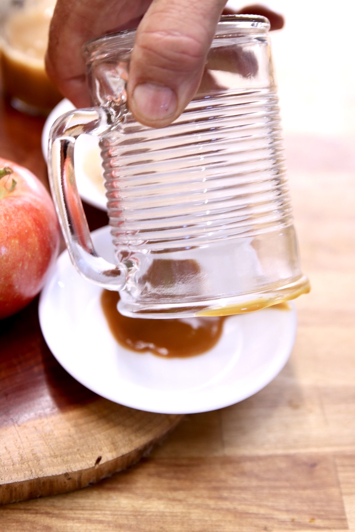 dipping glass into caramel syrup to coat the rim