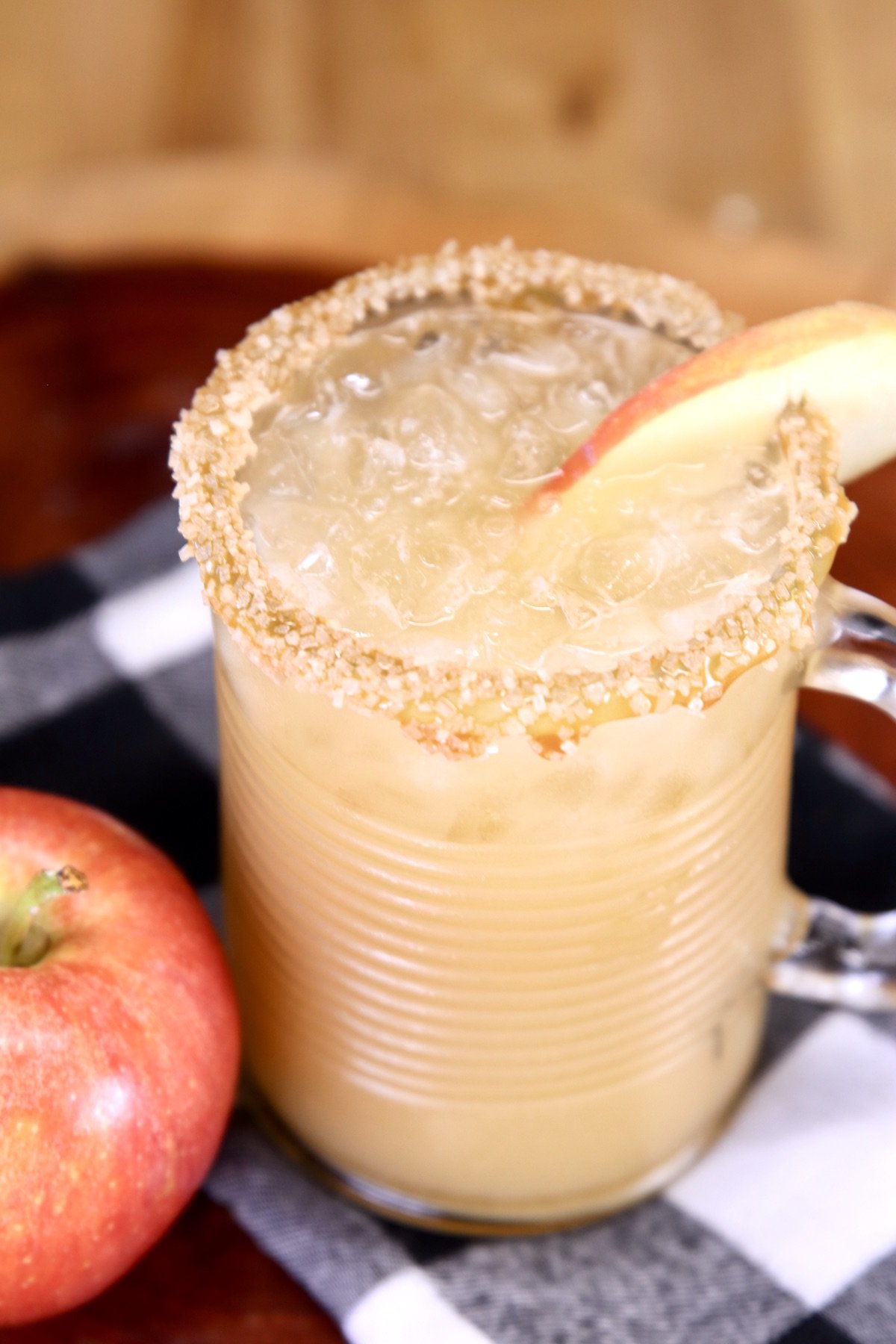 apple slice garnished caramel cocktail in a glass