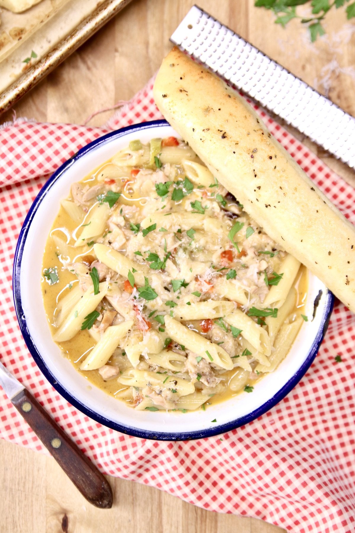 pasta bowl with a breadstick on the side