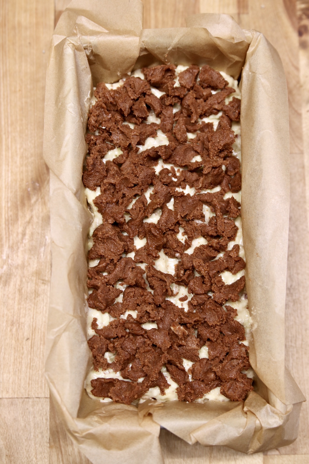 brown sugar cinnamon topped apple bread ready to bake in a loaf pan