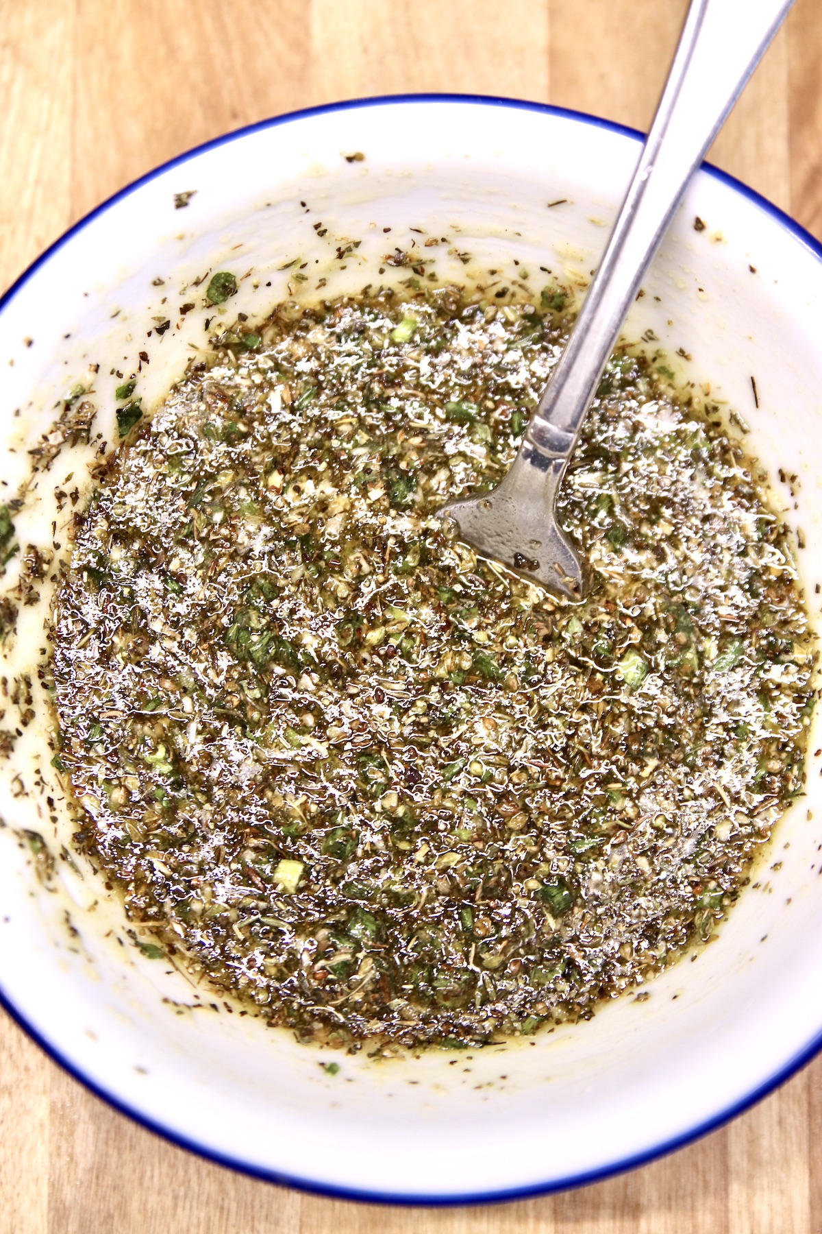 bowl with homemade Italian herb dressing with a fork