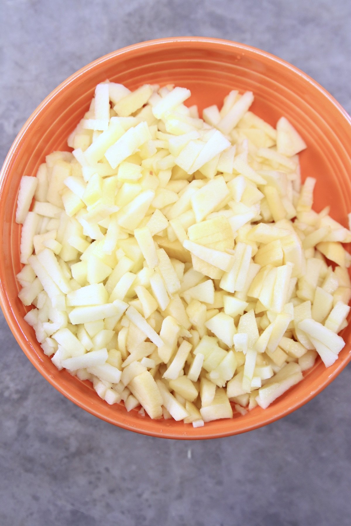 orange bowl filled with diced apples