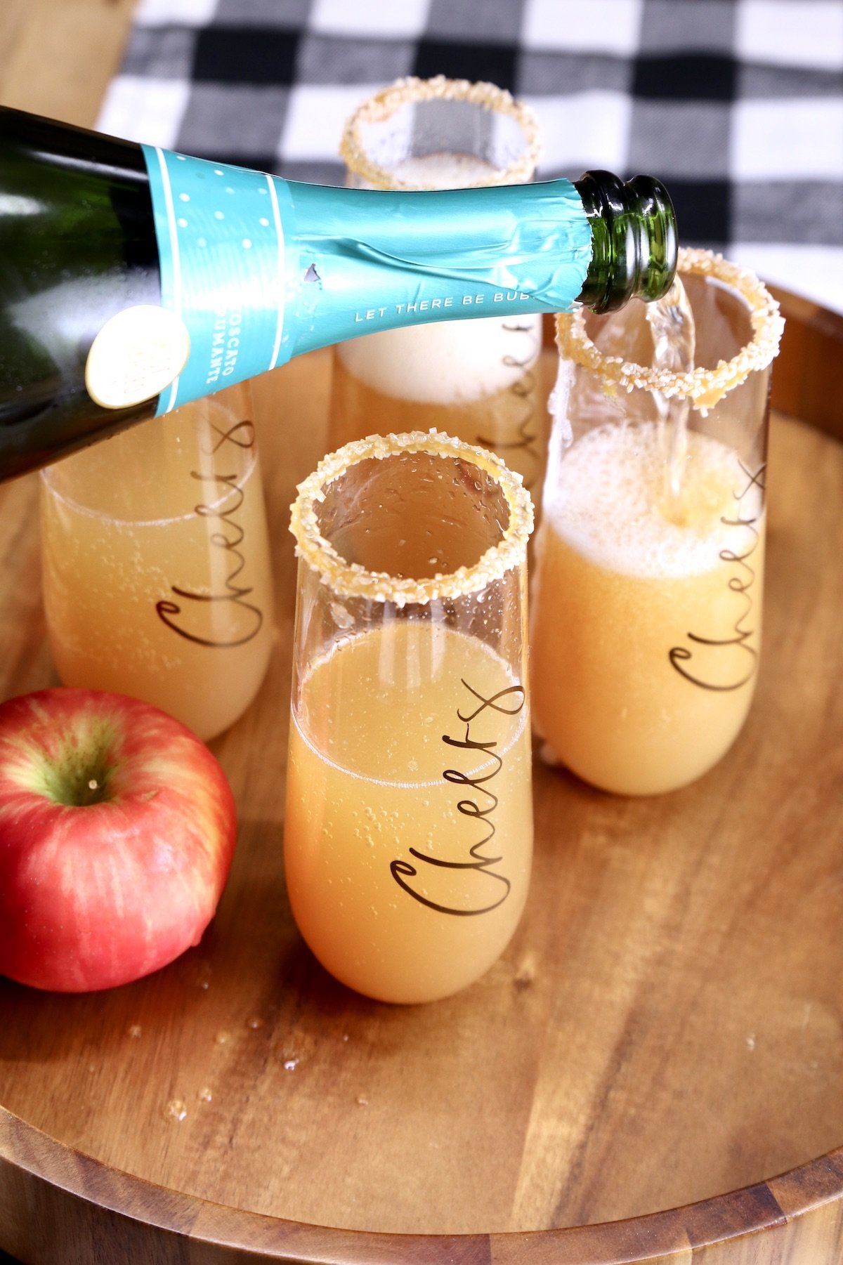 filling champagne glasses with sparkling wine
