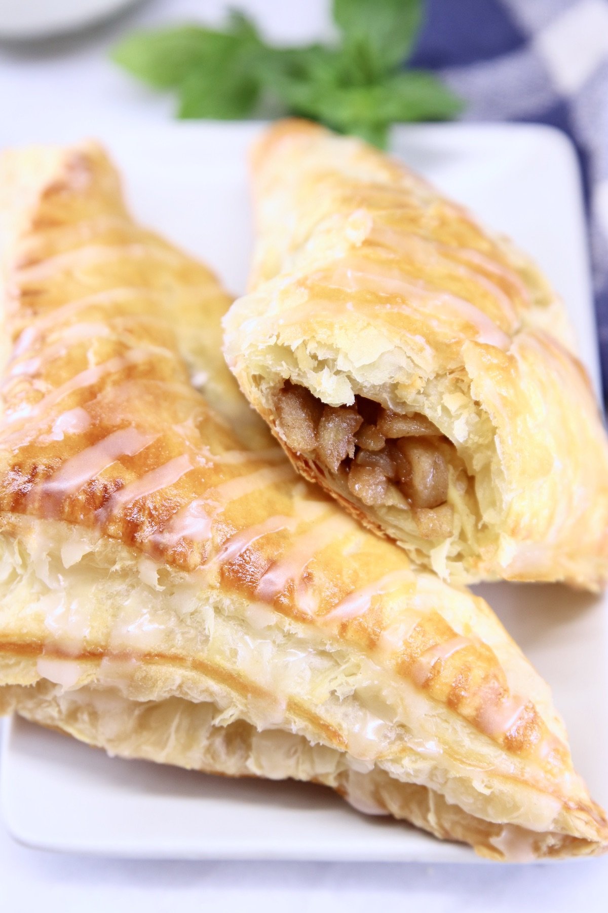2 apple turnovers one with apple pie filling showing